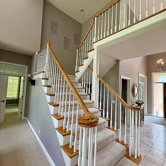 8255 Shady Brook Ln, Flushing, MI 48433 - stairway with a towering ceiling and a chandelier