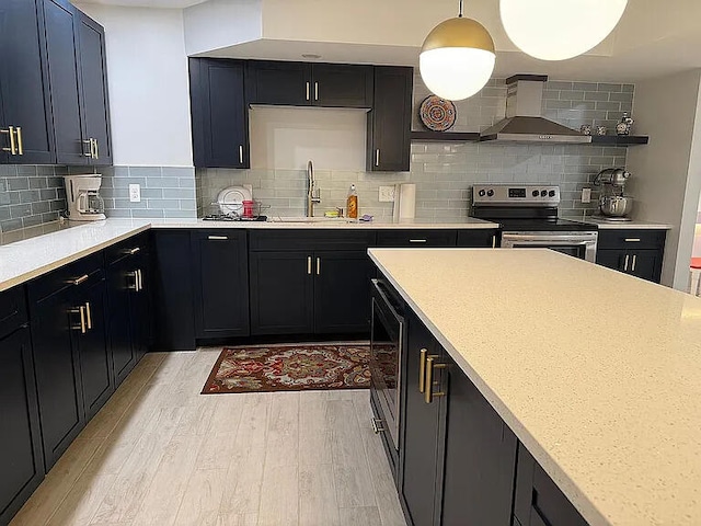 8255 Shady Brook Ln, Flushing, MI 48433 - kitchen with stainless steel electric range, wall chimney range hood, light wood finished floors, light countertops, and decorative backsplash