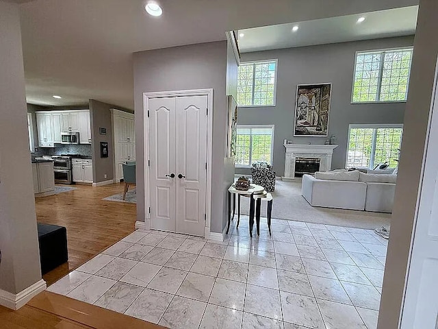 8255 Shady Brook Ln, Flushing, MI 48433 - foyer entrance with recessed lighting, a high ceiling, a fireplace, and light tile patterned floors