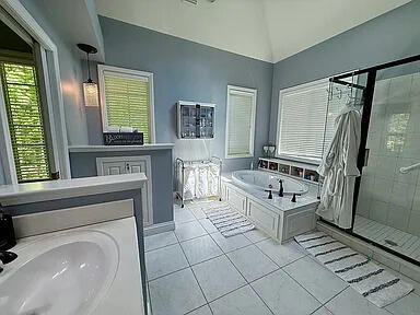 8255 Shady Brook Ln, Flushing, MI 48433 - full bath featuring a garden tub, a stall shower, tile patterned flooring, and lofted ceiling