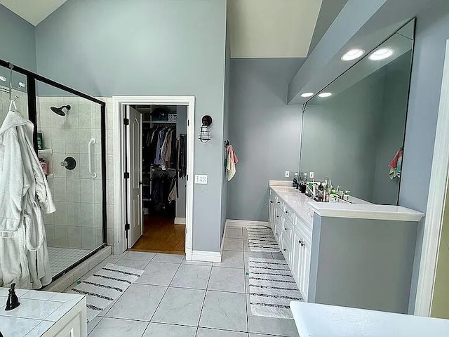 8255 Shady Brook Ln, Flushing, MI 48433 - bathroom with a stall shower, a walk in closet, tile patterned floors, and double vanity