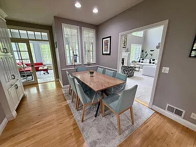 8255 Shady Brook Ln, Flushing, MI 48433 - dining area featuring light wood-style flooring, recessed lighting, healthy amount of natural light, and a fireplace