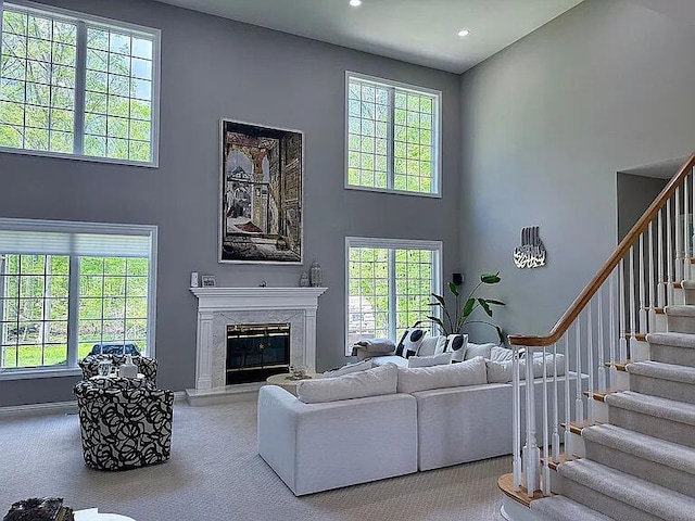 8255 Shady Brook Ln, Flushing, MI 48433 - living area with a towering ceiling, stairway, a premium fireplace, carpet flooring, and recessed lighting