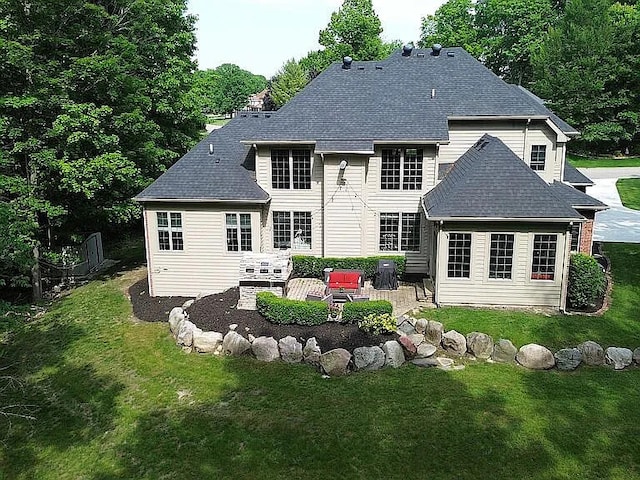8255 Shady Brook Ln, Flushing, MI 48433 - rear view of house with a patio area, a lawn, and a shingled roof