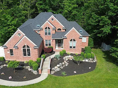 8255 Shady Brook Ln, Flushing, MI 48433 - view of front facade featuring a front yard, brick siding, and a view of trees