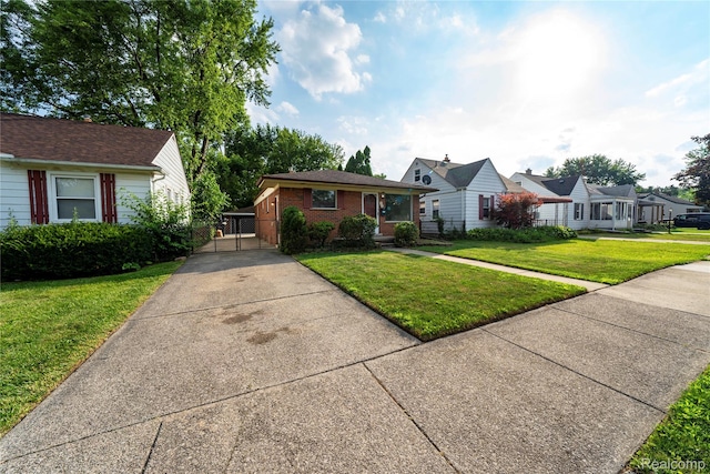 17213 Anne Ave, Detroit, MI 48101 - view of front of property featuring concrete driveway, a front yard, brick siding, and a residential view