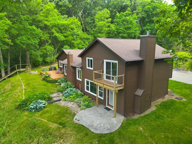 13955 Rattalee Lake Rd, Davisburg, MI 48350 - back of house featuring a patio area, a chimney, a yard, and roof with shingles