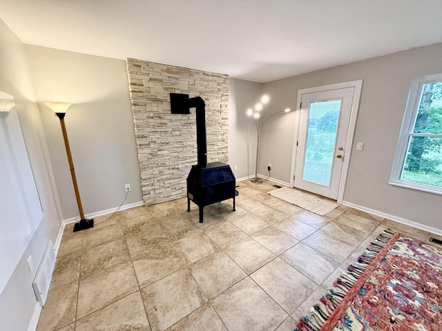 13955 Rattalee Lake Rd, Davisburg, MI 48350 - foyer entrance with a wood stove and baseboards