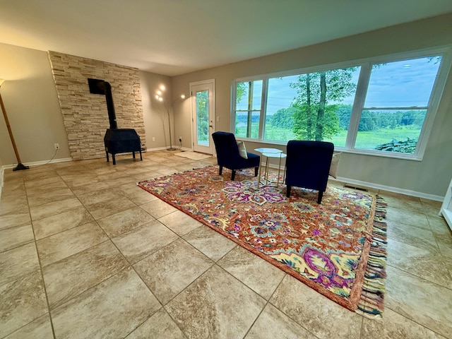 13955 Rattalee Lake Rd, Davisburg, MI 48350 - living area featuring a wood stove and baseboards