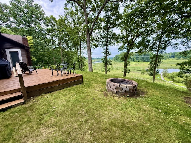 13955 Rattalee Lake Rd, Davisburg, MI 48350 - view of grassy yard featuring an outdoor fire pit and a deck with water view