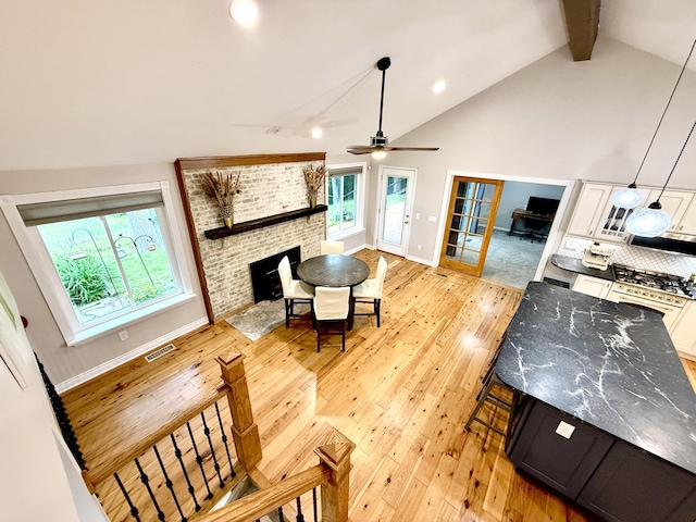 13955 Rattalee Lake Rd, Davisburg, MI 48350 - living room with light wood-type flooring, beam ceiling, high vaulted ceiling, ceiling fan, and recessed lighting