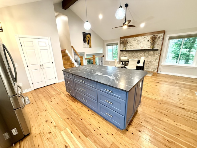 13955 Rattalee Lake Rd, Davisburg, MI 48350 - kitchen with stainless steel refrigerator, ceiling fan, beamed ceiling, light wood-style floors, and pendant lighting