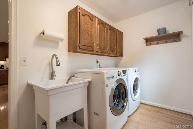2732 Winter Park Ct, Rochester Hills, MI 48309 - laundry room featuring washer and clothes dryer, light wood-type flooring, and cabinet space