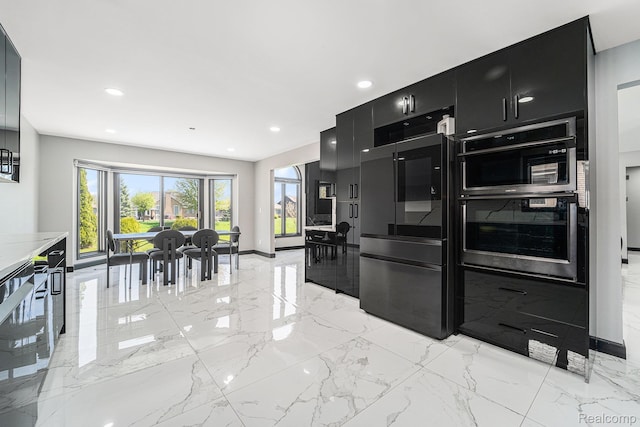53242 Clarion Dr, Macomb, MI 48042 - kitchen featuring dark cabinets, refrigerator, light marble finish flooring, stainless steel double oven, and recessed lighting