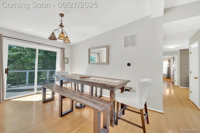 1522 Oregon Ct, Waterford, MI 48327 - dining space with light wood-type flooring and vaulted ceiling