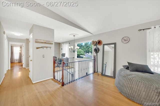 1522 Oregon Ct, Waterford, MI 48327 - corridor with a chandelier, light wood finished floors, an upstairs landing, and vaulted ceiling
