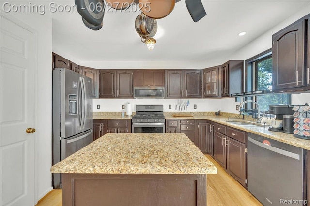1522 Oregon Ct, Waterford, MI 48327 - kitchen featuring stainless steel appliances, light wood-style floors, dark brown cabinetry, and light stone counters