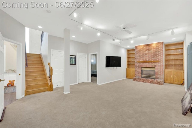 1522 Oregon Ct, Waterford, MI 48327 - unfurnished living room with rail lighting, a ceiling fan, light colored carpet, and stairs