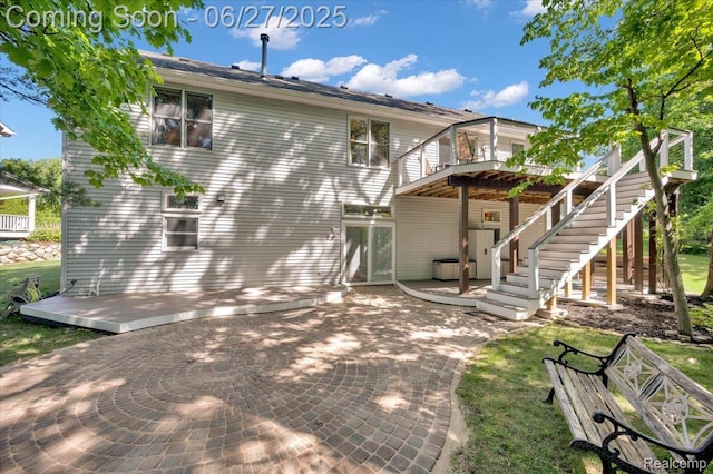 1522 Oregon Ct, Waterford, MI 48327 - rear view of house featuring a patio area, a wooden deck, and stairway