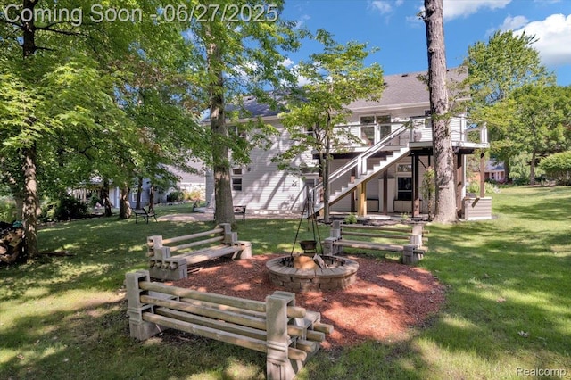 1522 Oregon Ct, Waterford, MI 48327 - view of green lawn featuring a fire pit, stairs, and a wooden deck