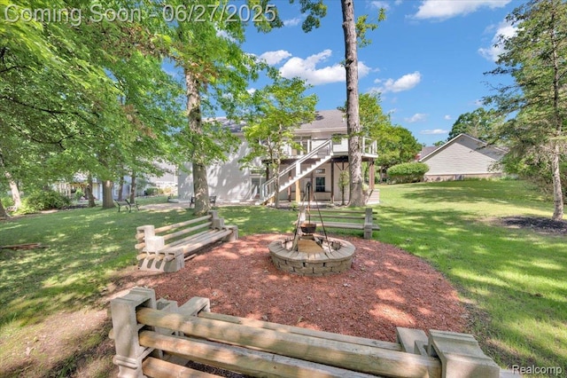 1522 Oregon Ct, Waterford, MI 48327 - view of grassy yard featuring stairs, an outdoor fire pit, and a wooden deck