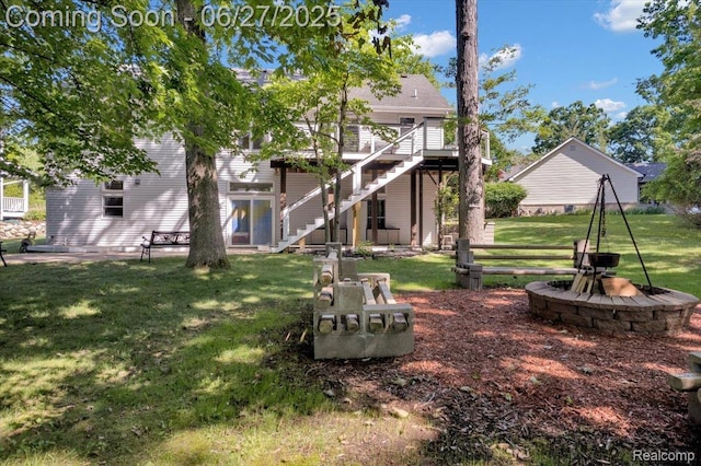 1522 Oregon Ct, Waterford, MI 48327 - view of green lawn with stairs, an outdoor fire pit, and a deck