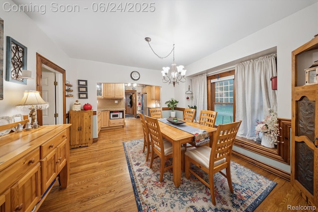 8450 Rosbolt Rd, Willis, MI 48191 - dining space featuring a chandelier and light wood-type flooring