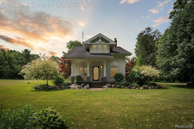8450 Rosbolt Rd, Willis, MI 48191 - view of front of property featuring a lawn, covered porch, and a chimney