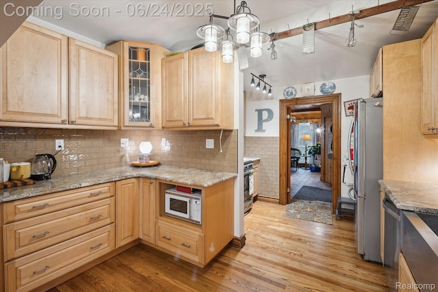 8450 Rosbolt Rd, Willis, MI 48191 - kitchen with appliances with stainless steel finishes, light brown cabinets, light wood-style floors, glass insert cabinets, and light stone counters