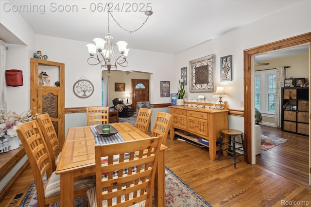 8450 Rosbolt Rd, Willis, MI 48191 - dining space featuring a chandelier and light wood-style floors