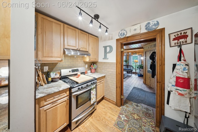 8450 Rosbolt Rd, Willis, MI 48191 - kitchen featuring stainless steel stove, under cabinet range hood, light wood-style floors, track lighting, and light brown cabinets