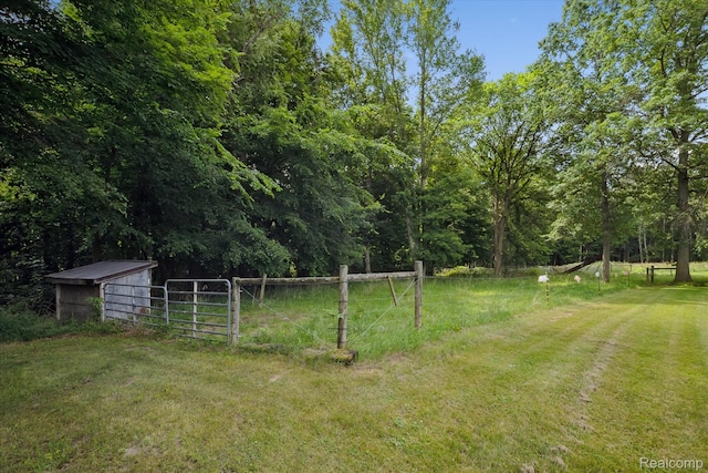8450 Rosbolt Rd, Willis, MI 48191 - view of yard with an outdoor structure and a wooded view