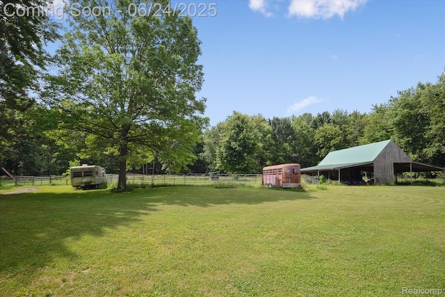 8450 Rosbolt Rd, Willis, MI 48191 - view of yard featuring an outbuilding, a carport, a pole building, and a forest view