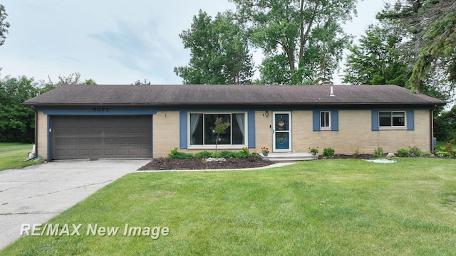 5071 Heidi Ln, Saginaw, MI 48604 - single story home with brick siding, a garage, driveway, and a front lawn