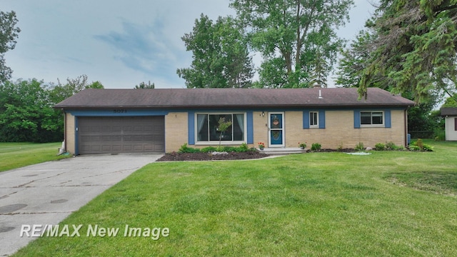 5071 Heidi Ln, Saginaw, MI 48604 - ranch-style home featuring an attached garage, concrete driveway, brick siding, and a front yard