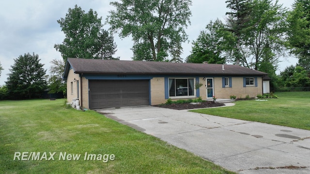 5071 Heidi Ln, Saginaw, MI 48604 - ranch-style home featuring a garage, driveway, brick siding, and a front yard