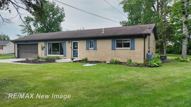 5071 Heidi Ln, Saginaw, MI 48604 - ranch-style home featuring brick siding, an attached garage, a front lawn, and concrete driveway