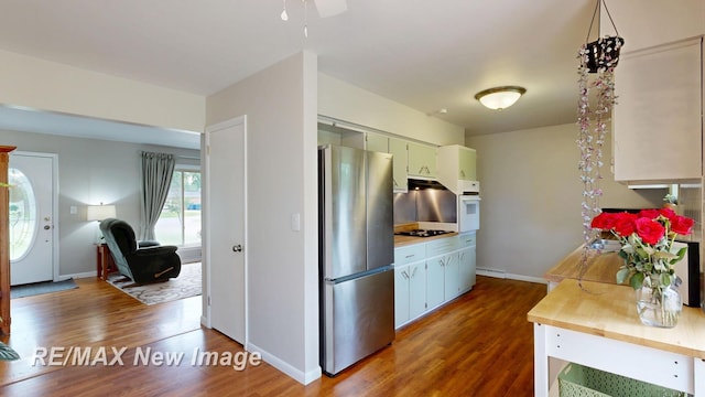 5071 Heidi Ln, Saginaw, MI 48604 - kitchen with freestanding refrigerator, white oven, wood finished floors, and light countertops