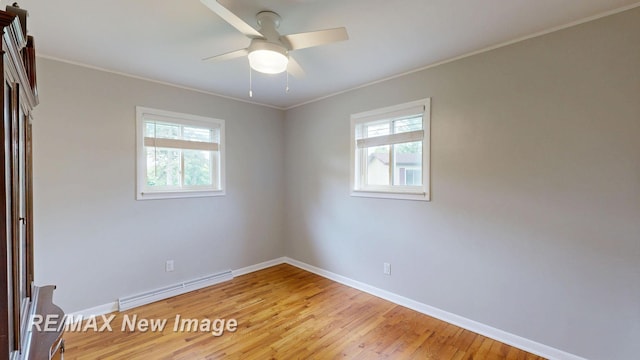 5071 Heidi Ln, Saginaw, MI 48604 - spare room featuring a baseboard radiator, plenty of natural light, light wood-type flooring, ornamental molding, and ceiling fan