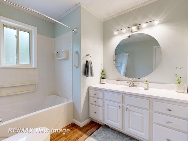 5071 Heidi Ln, Saginaw, MI 48604 - full bathroom featuring ornamental molding, vanity, wood finished floors, and washtub / shower combination