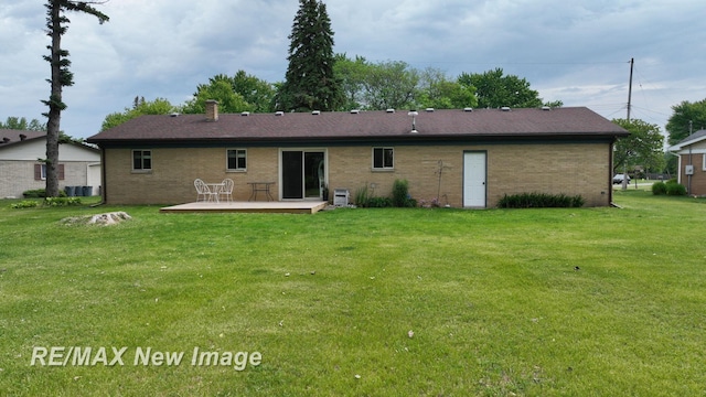 5071 Heidi Ln, Saginaw, MI 48604 - back of property with a wooden deck, a lawn, and brick siding