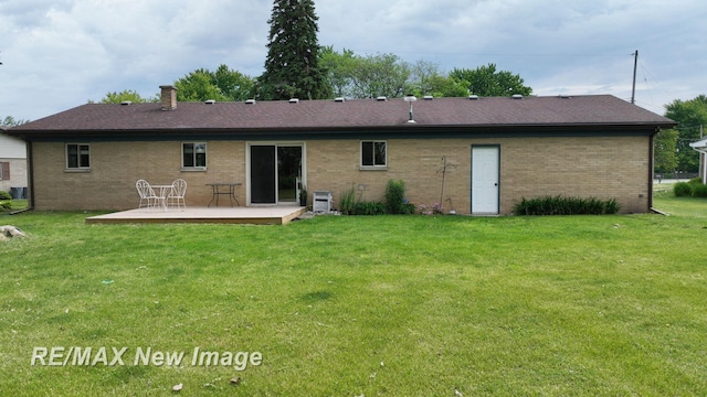 5071 Heidi Ln, Saginaw, MI 48604 - back of house with a deck, brick siding, and a lawn