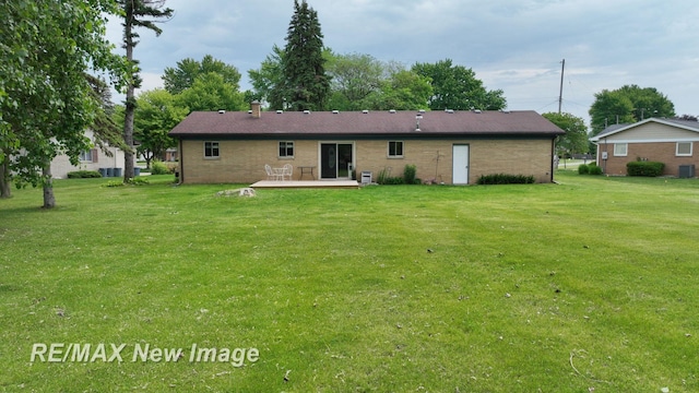 5071 Heidi Ln, Saginaw, MI 48604 - back of property featuring a yard, a deck, and brick siding