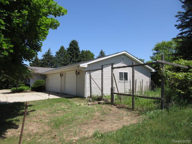 3521 Brandt Ln, Metamora, MI 48455 - view of side of property featuring an attached garage