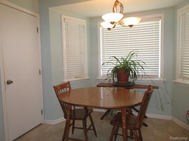 3521 Brandt Ln, Metamora, MI 48455 - dining area featuring baseboards and a chandelier
