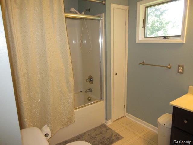 3521 Brandt Ln, Metamora, MI 48455 - bathroom featuring vanity and combined bath / shower with glass door