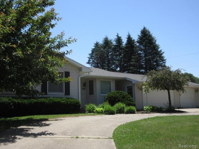3521 Brandt Ln, Metamora, MI 48455 - ranch-style home with an attached garage, driveway, and a front yard