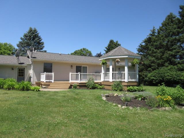 3521 Brandt Ln, Metamora, MI 48455 - view of front of home with a front lawn, a wooden deck, and a gazebo