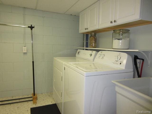 3521 Brandt Ln, Metamora, MI 48455 - laundry room with concrete block wall, washing machine and dryer, and cabinet space