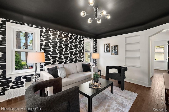 2718 Hubbard St, Dearborn, MI 48124 - living area featuring wood finished floors, built in features, and a chandelier